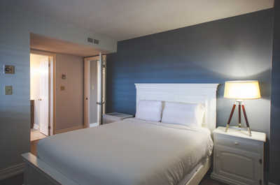Rest easy in the master bedroom with a plush queen-sized bed and modern decor.