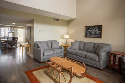 Another angle of the living room showcasing comfortable seating and an inviting atmosphere.