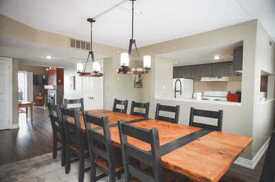 Host family dinners in the elegant dining area with a large table and stylish lighting.