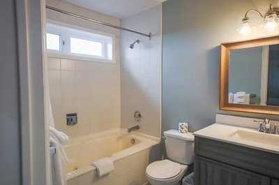 Freshen up in the modern bathroom featuring a bathtub and stylish fixtures.
