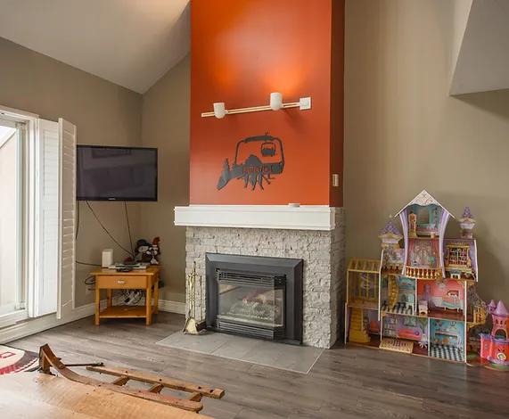 image Enjoy a cozy evening by the gas fireplace in this charming and inviting living area.