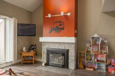 Enjoy a cozy evening by the gas fireplace in this charming and inviting living area.