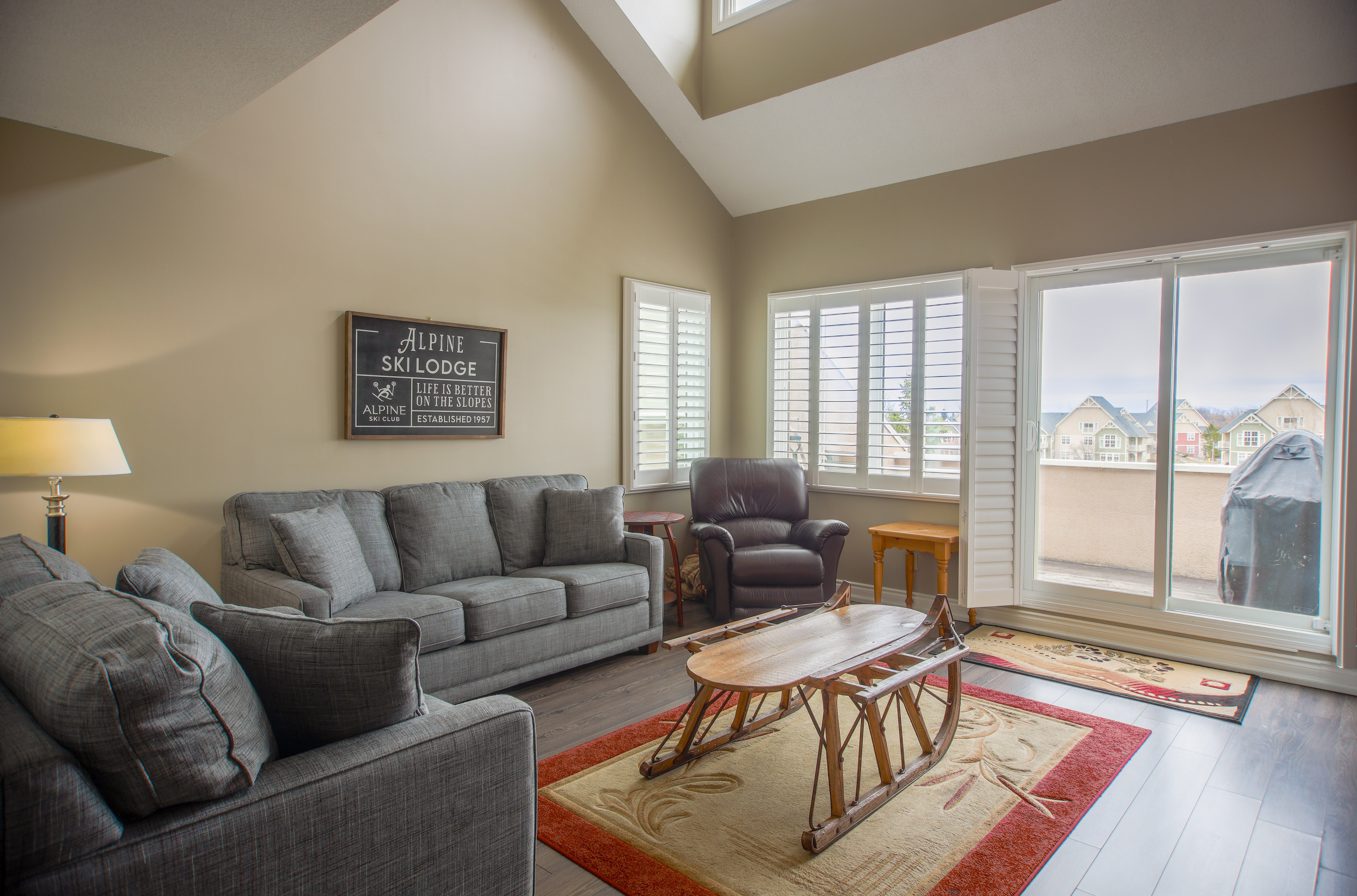 image Relax in the spacious living room featuring comfortable sofas and large windows with stunning views.