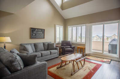 Relax in the spacious living room featuring comfortable sofas and large windows with stunning views.