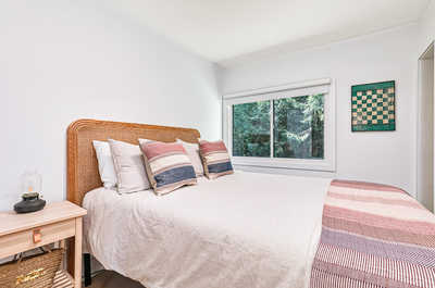 Comfortable bedroom with a queen bed and natural light, offering a restful night’s sleep