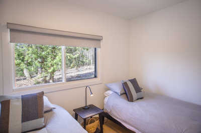 Bright and airy bedroom with twin beds, perfect for children or friends sharing a room.