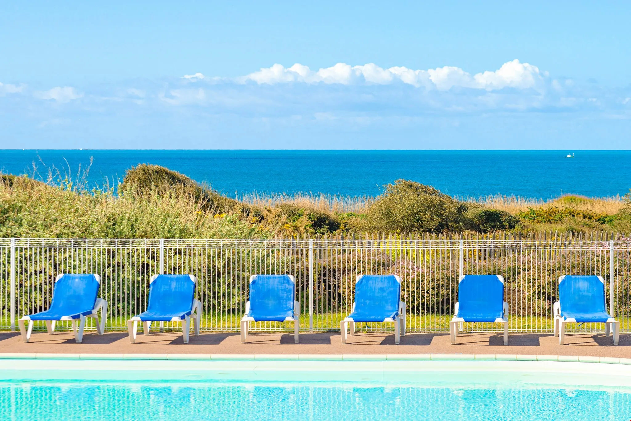 image Enjoy seaside views right from the shared swimming pool.