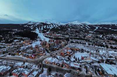 Stunning aerial view of a charming ski town nestled in the heart of the mountains, where adventure and relaxation meet.