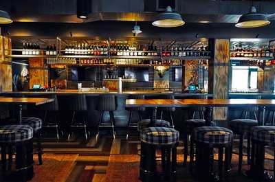 Cozy and rustic dining experience with a lively atmosphere, handcrafted cocktails, and delicious bites to savor.