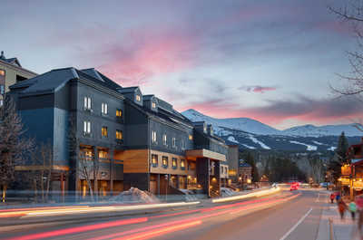 As the sun sets, the town comes to life with warm lights, scenic streets, and a cozy mountain-town atmosphere.