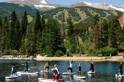 Serene mountain lake adventure with paddleboarders enjoying the fresh air and stunning natural surroundings.