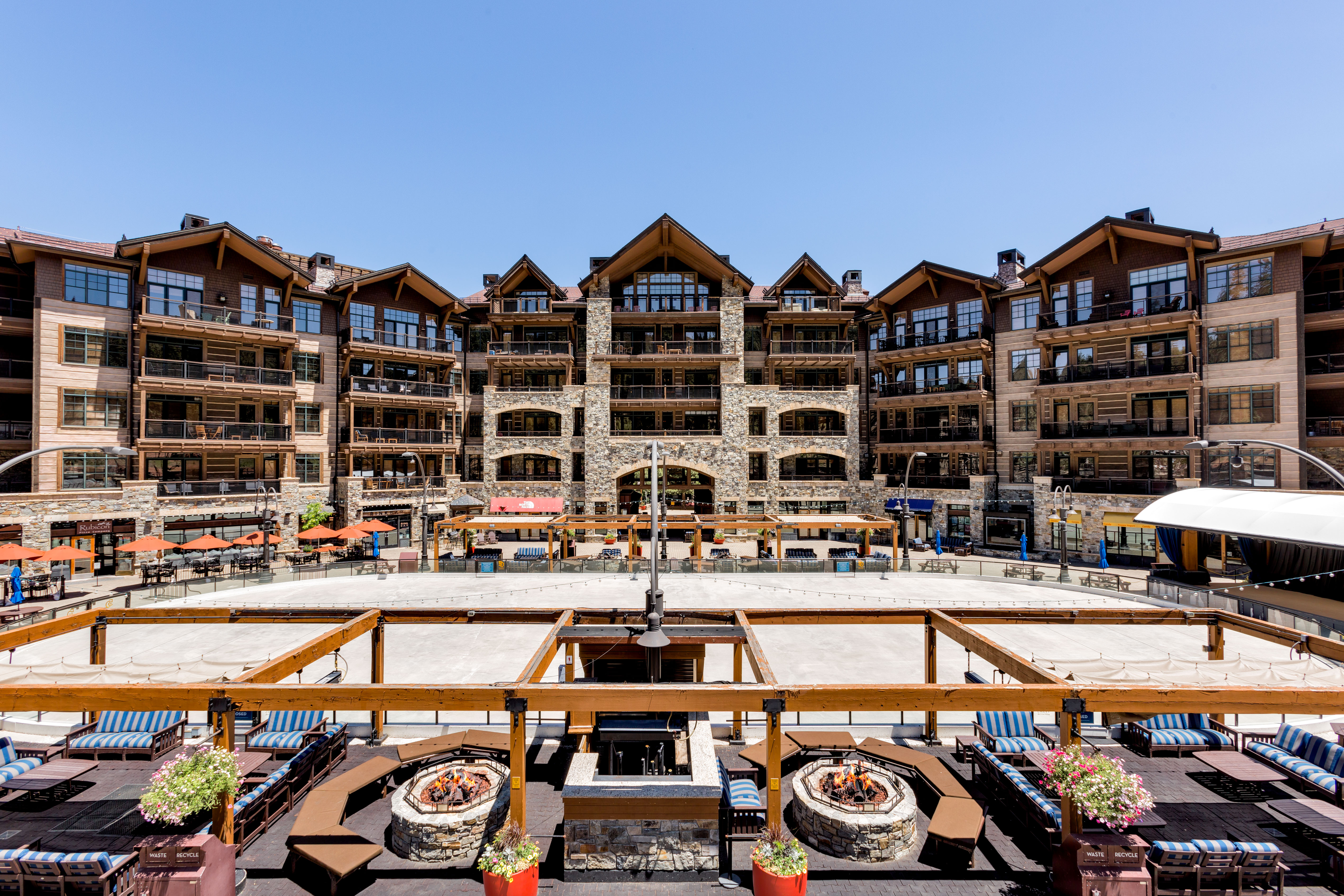 image Savor mountain views from the expansive terrace, complete with inviting seating for enjoying a relaxing drink or meal.