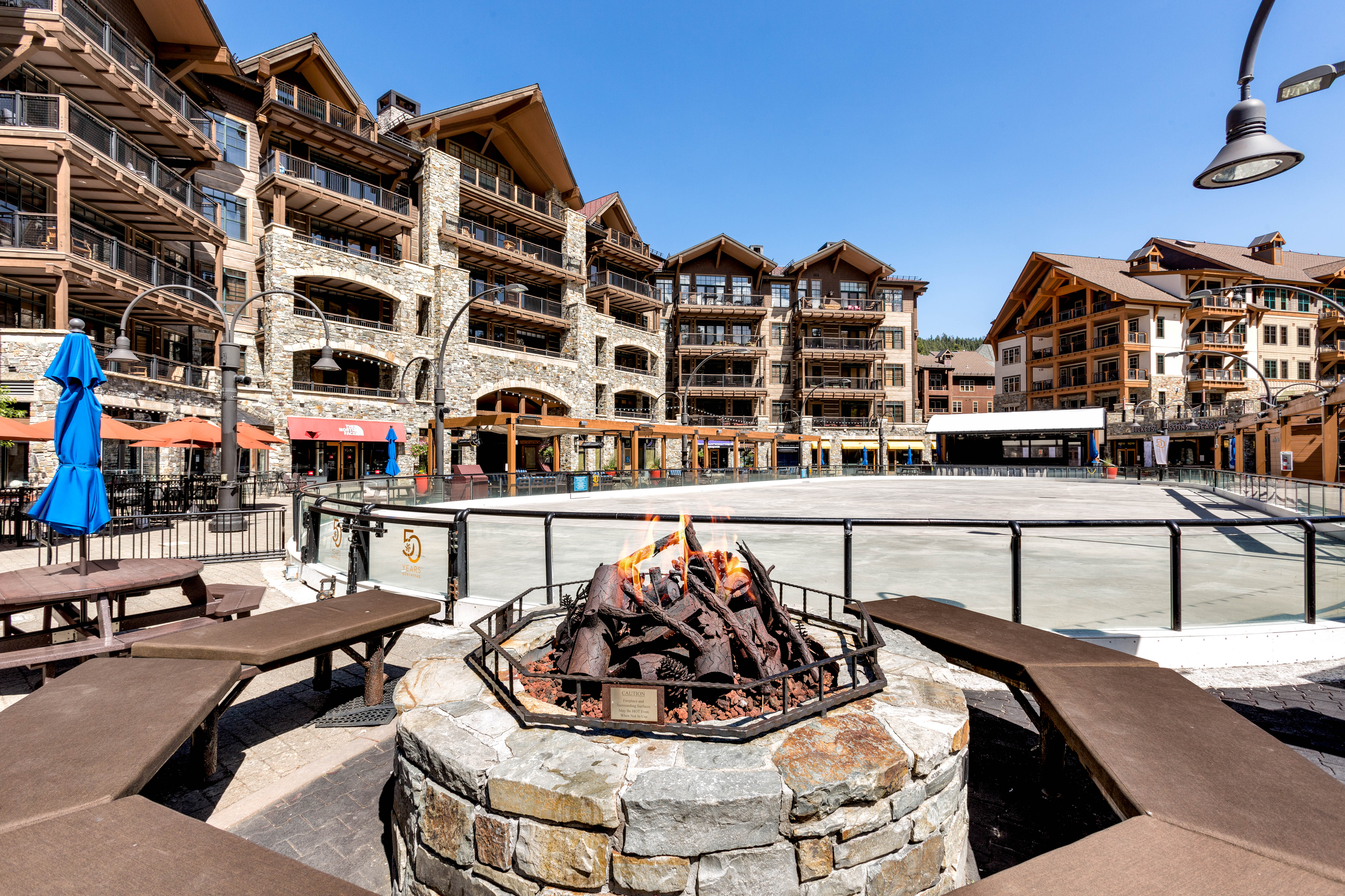 image Gather around the outdoor fire pit for cozy evenings with friends, surrounded by the charm of the lodge-style architecture.