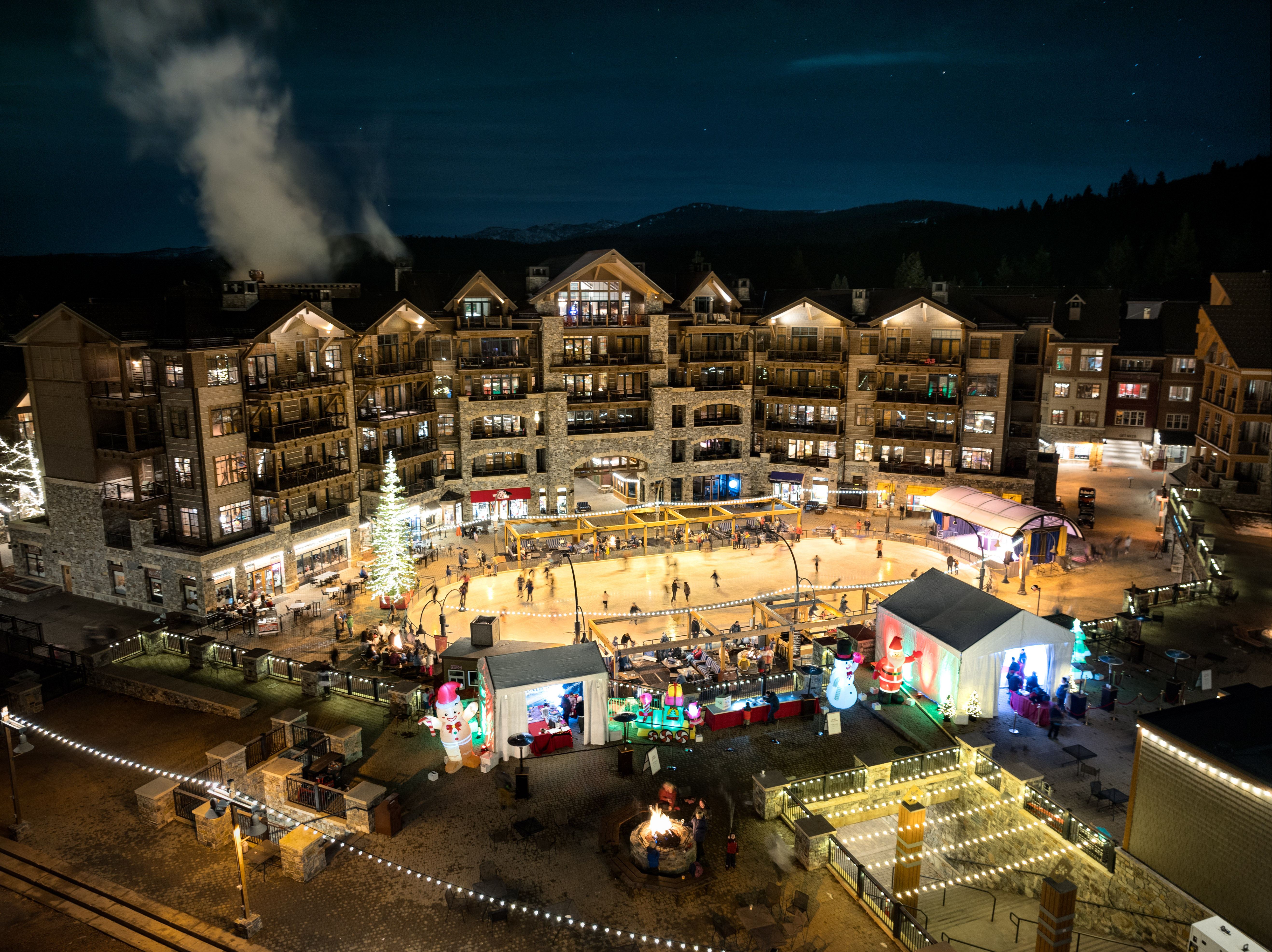 image Experience the lively ambiance of this bustling mountain village at night, illuminated by twinkling lights and the energy of the resort.