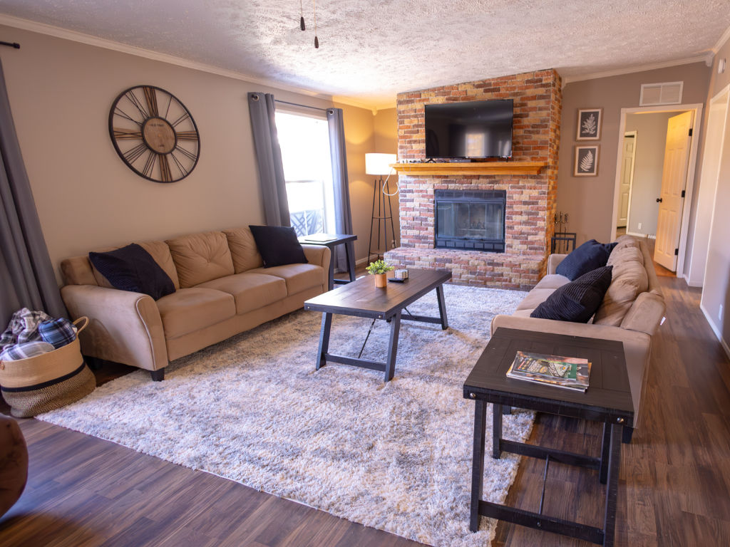 image Relax in this inviting living room, featuring plenty of comfortable seating for family gatherings and unwinding after a day of adventure.