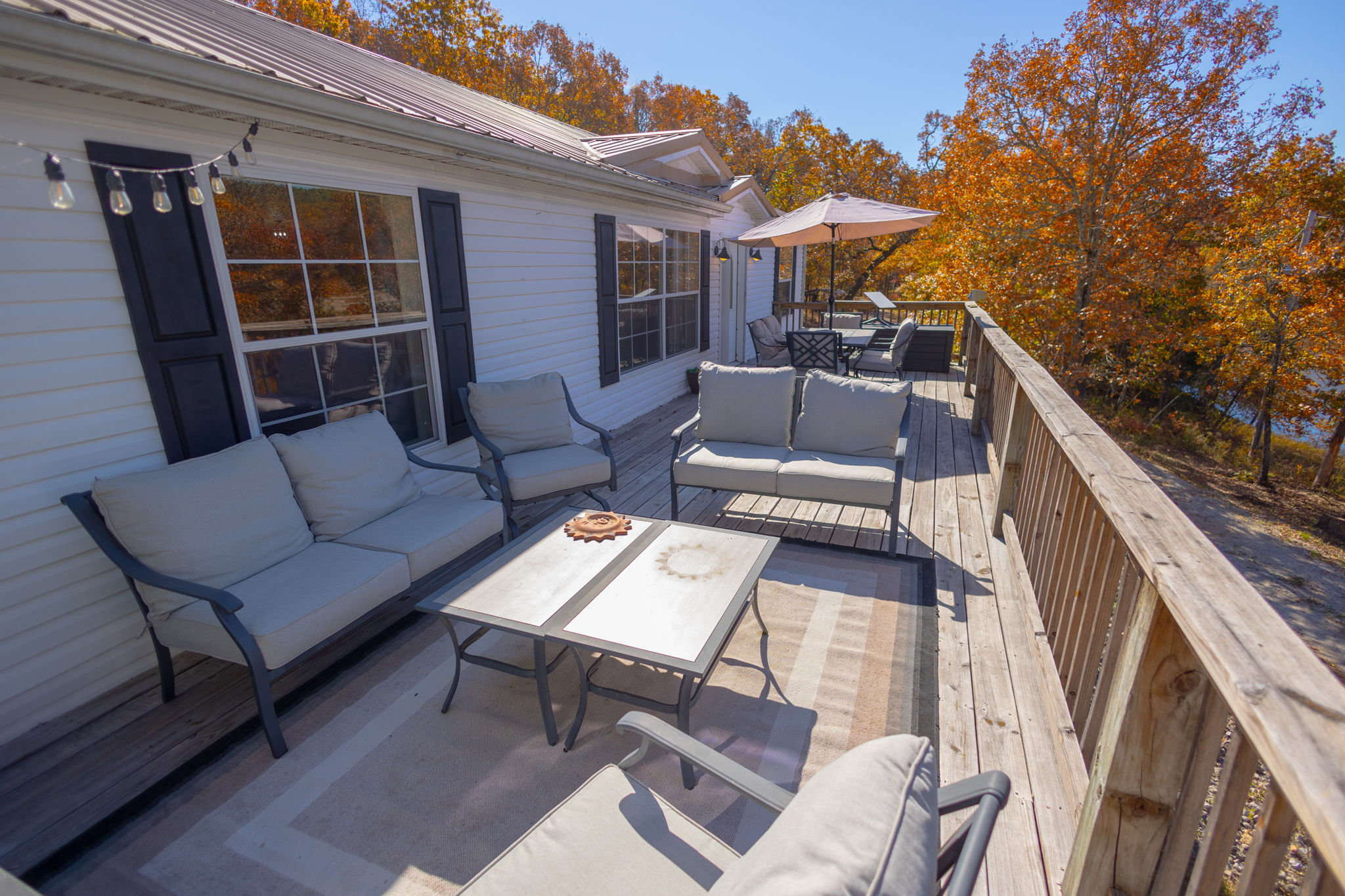 image Enjoy meals al fresco on the spacious deck with comfortable seating and views of the surrounding nature.
