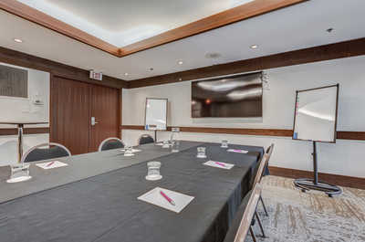 Versatile meeting room with modern amenities, perfect for workshops.