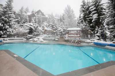 Heated pool surrounded by snow. Ski right to your door.