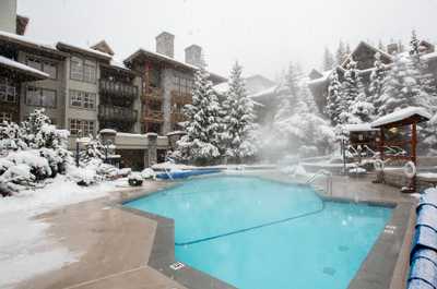 Heated outdoor pool with snowy mountain views. Ski-in, ski-out convenience!
