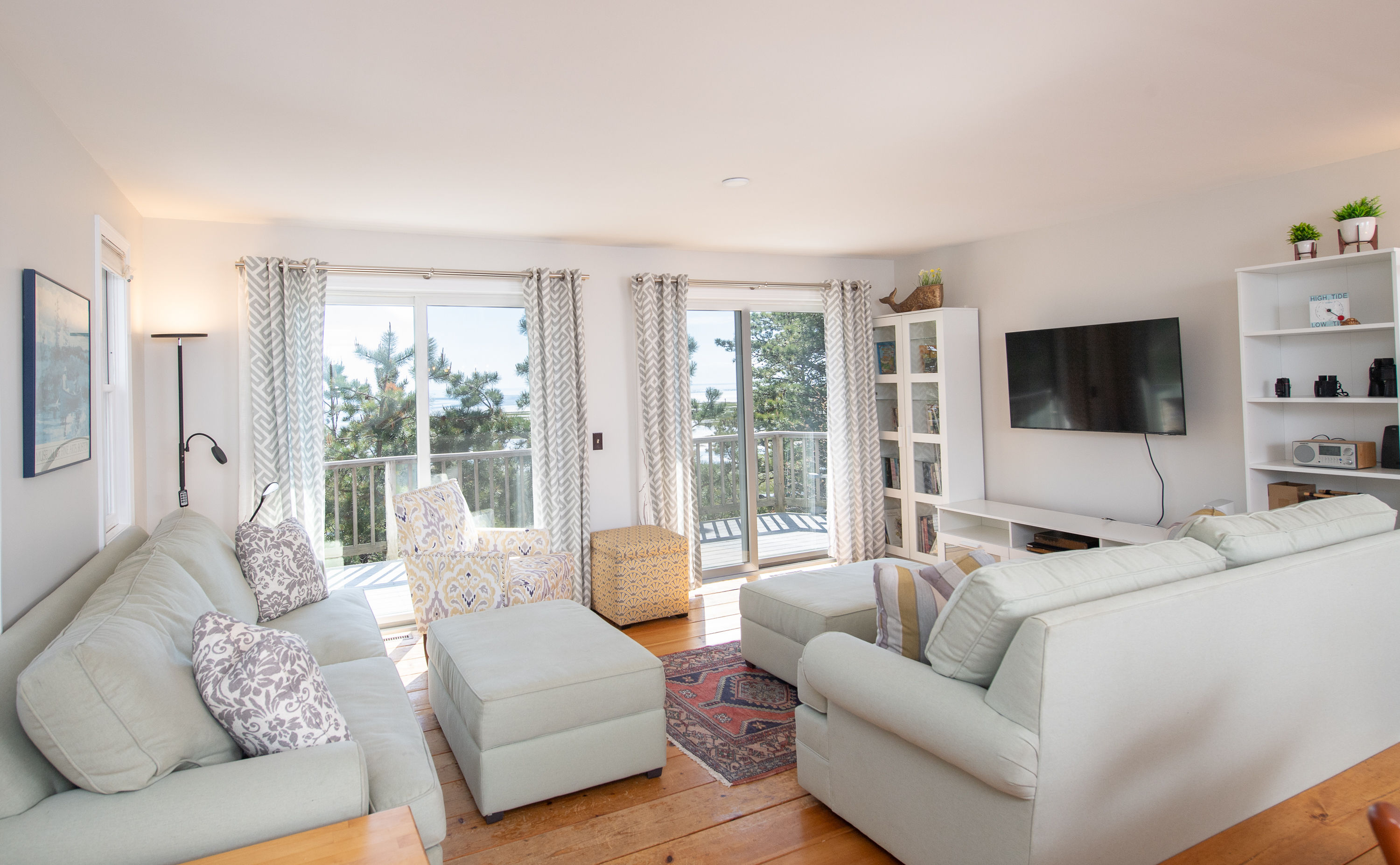 image Bright and open living room with comfortable seating and large windows showcasing beautiful outdoor views.
