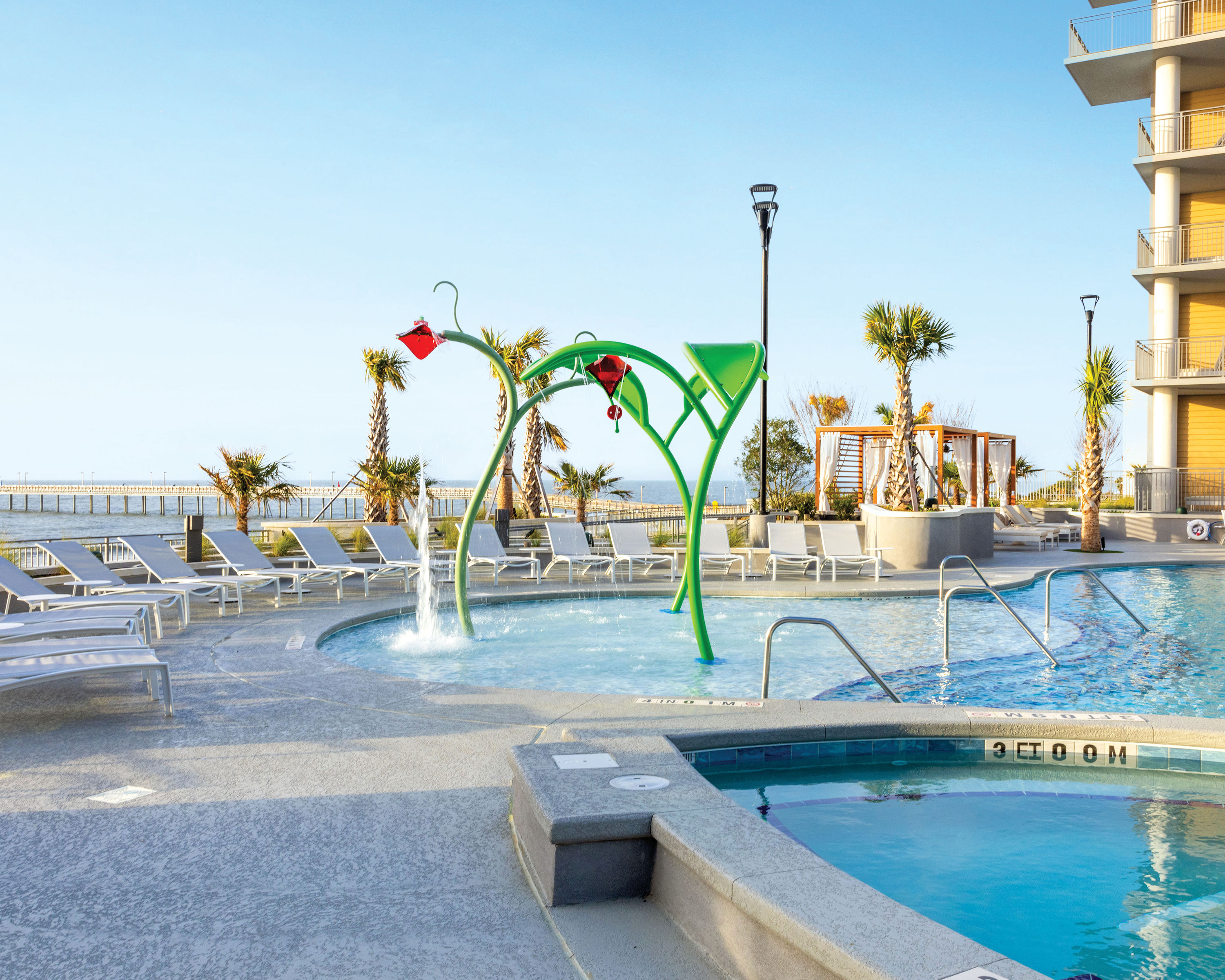 image Soak up the sun in the poolside area with comfortable lounge chairs and ocean views.