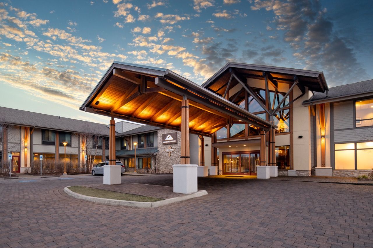 image A warm welcome awaits beneath the beautifully lit entrance of this mountain retreat.