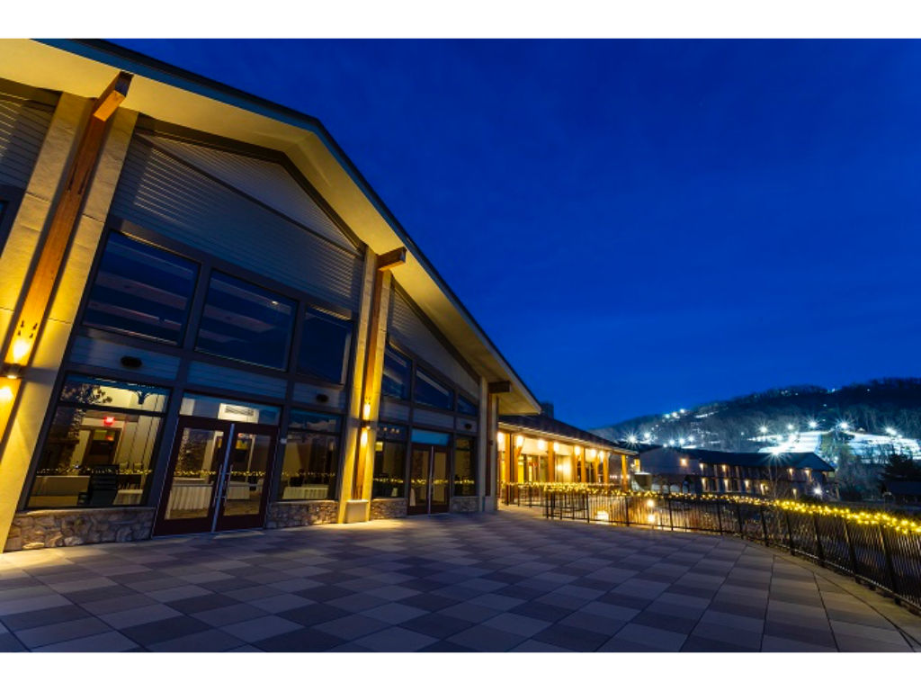 image The lodge shines under the night sky, offering a perfect blend of elegance and comfort.