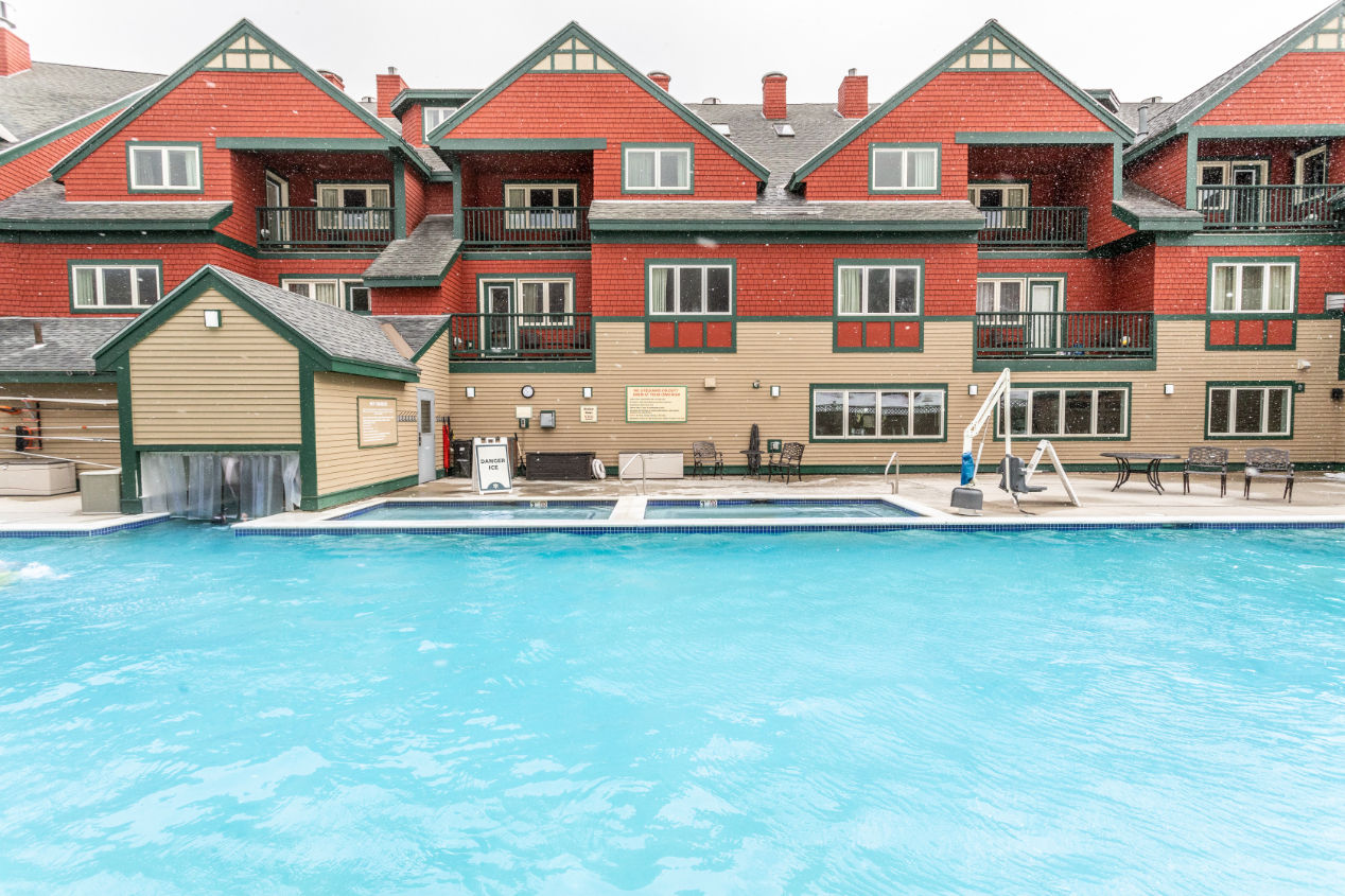 image Soak up the mountain air and take a dip in the inviting outdoor pool, a perfect retreat in any season.