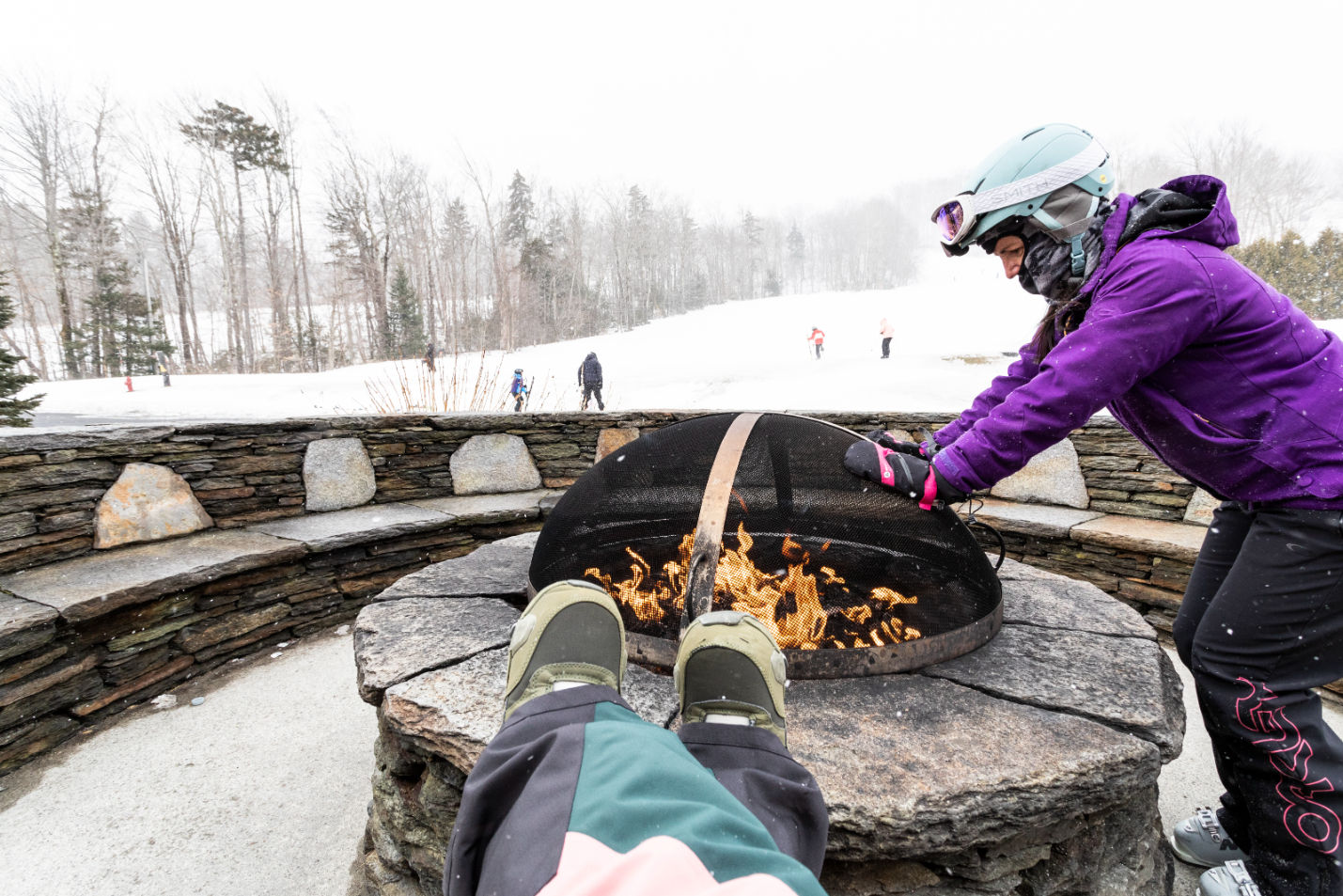 image Unwind after a day on the slopes with a fireside moment, where crisp mountain air meets the warmth of a crackling flame.