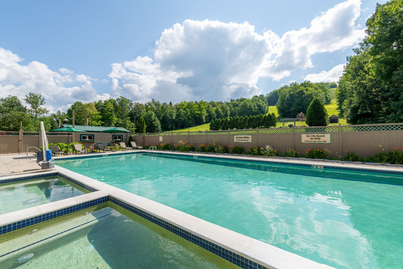 image Relax and recharge in a peaceful poolside setting, surrounded by Vermont’s natural beauty.