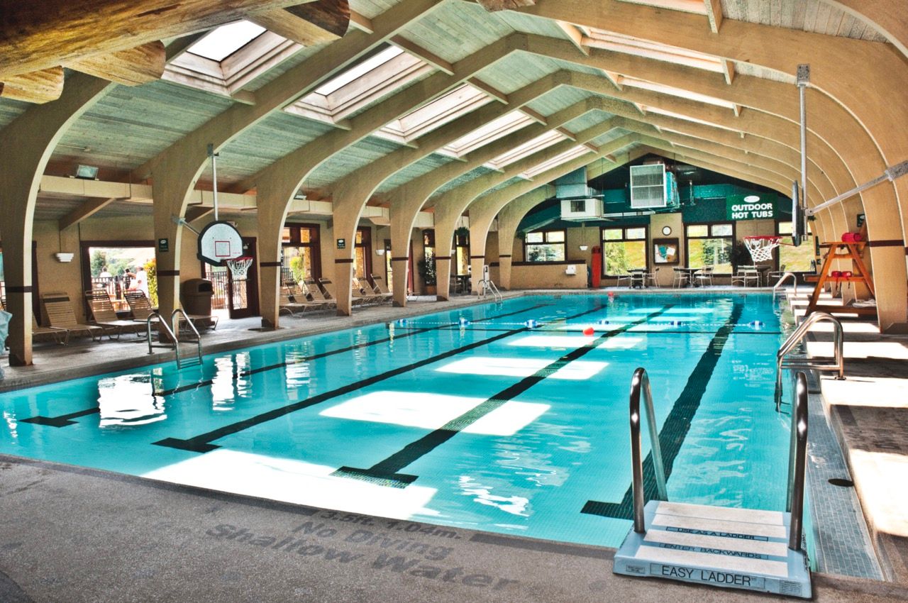 image Bright indoor pool with soaring ceilings and abundant natural light, perfect for a relaxing swim in any season.