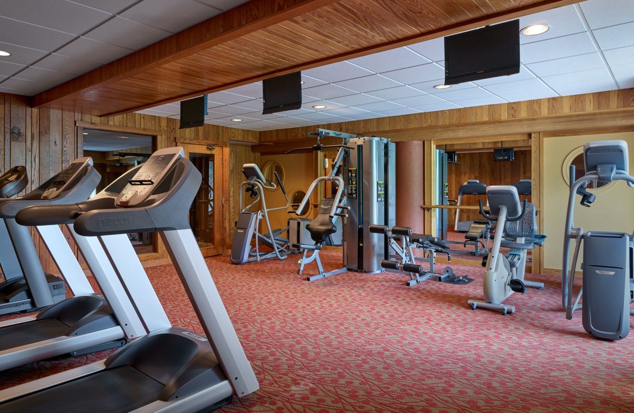 image Well-equipped fitness center with natural light and modern machines, offering a comfortable space to stay active.