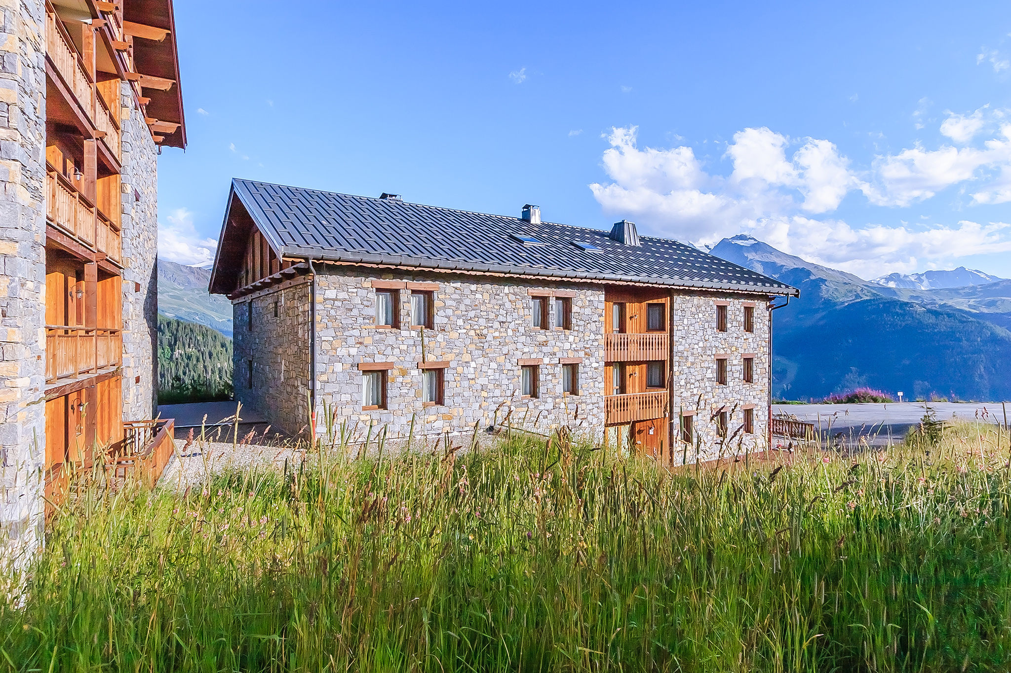 image Bathed in sunshine and nestled in a peaceful meadow, this inviting stone retreat is perfect for a quiet summer getaway.