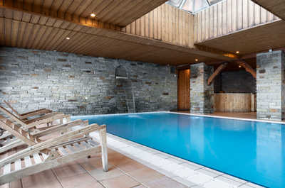 After a day in the snow, unwind in the resort's inviting indoor pool, offering a perfect retreat from the cold with relaxing mountain views.