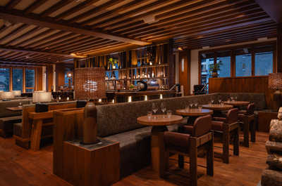 Good Folk restaurant, a rustic dining area with warm lighting and expansive wooden details, creating the perfect setting for intimate gatherings and delicious meals.