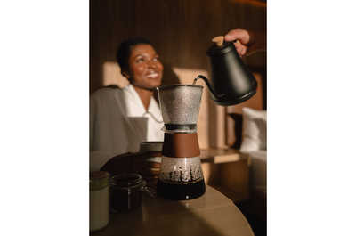 A tranquil moment of self-care as freshly brewed coffee is poured, setting the tone for a leisurely and rejuvenating stay.