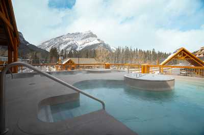 Soak in the hot tub with mountain views stretching out before you, steam rising against the cold alpine air.