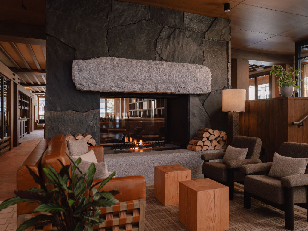 image A cozy lounge space centered around a grand stone fireplace, exuding warmth and inviting relaxation after a long day of exploring.