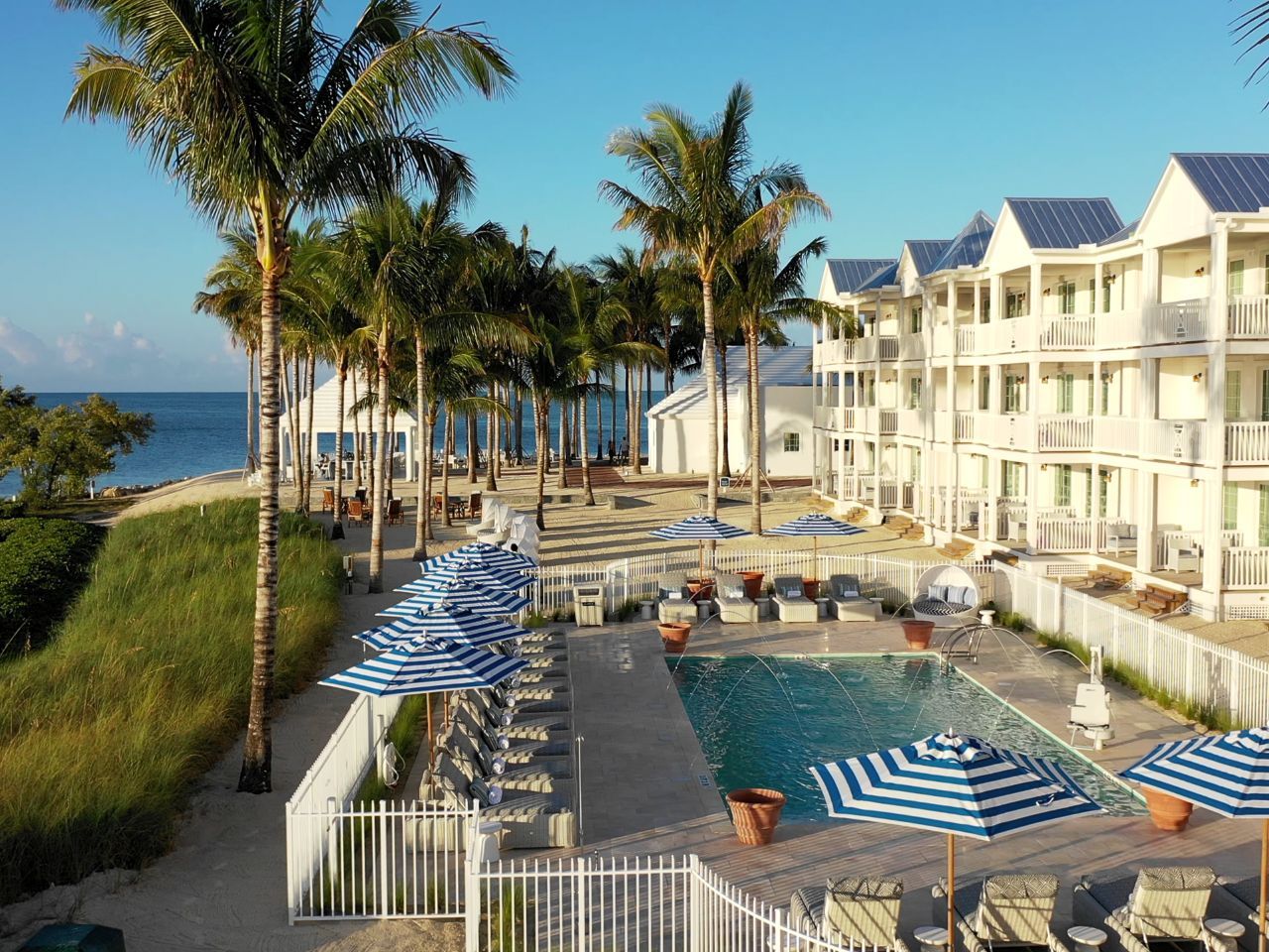image Vibrant poolside retreat overlooking the shoreline, designed for unwinding in sunlit comfort.