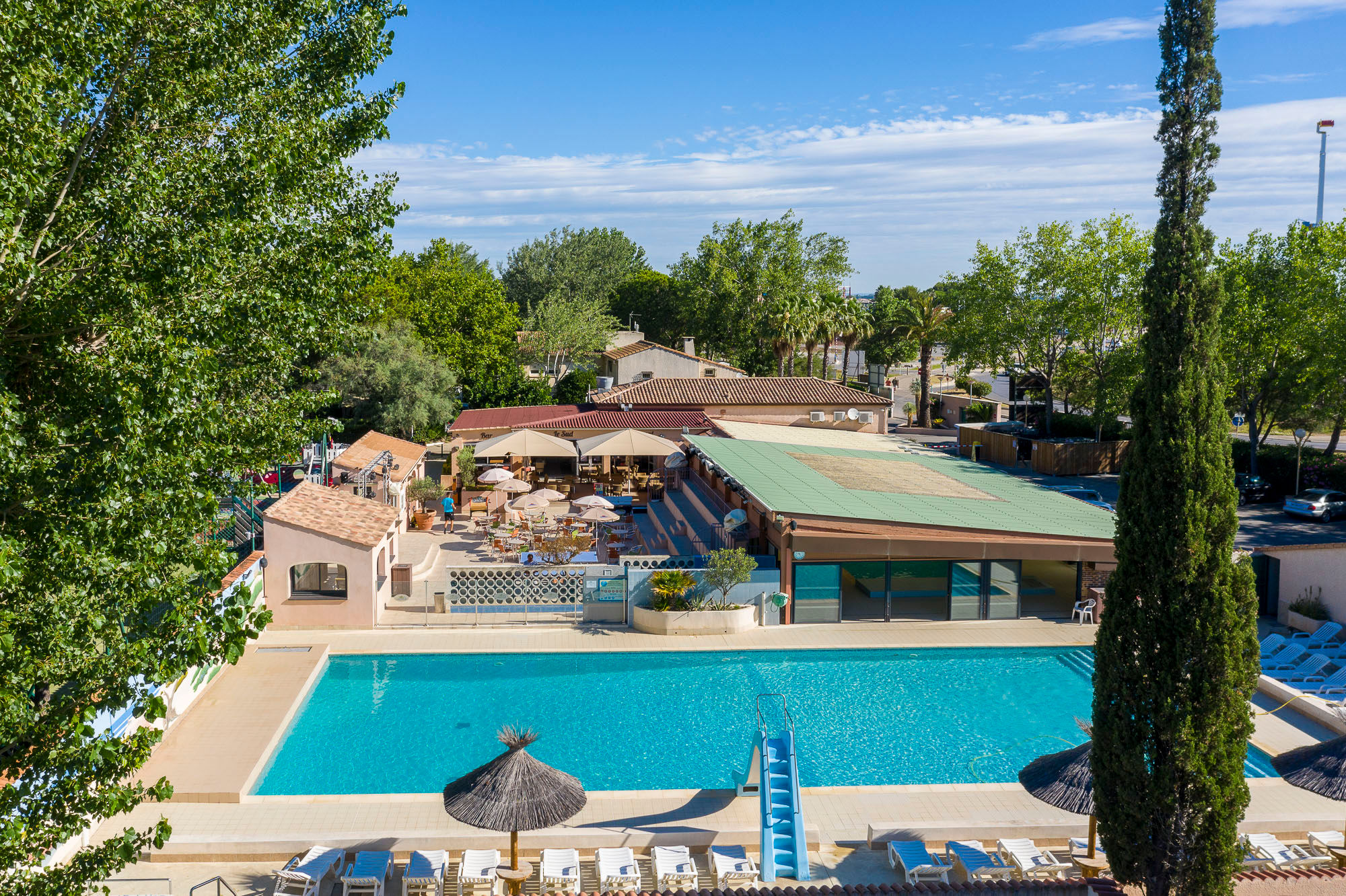 image Unwind at the expansive outdoor pool, a highlight of Camping Village Abri de Camargue.