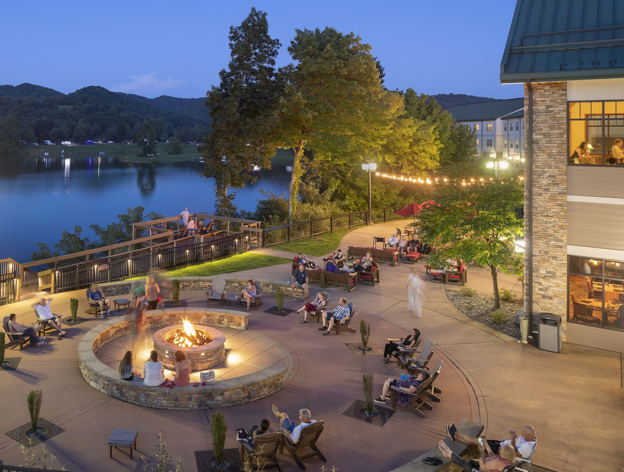 image Lakeside patios come alive with laughter and firelight, perfect for ending the day under the stars.