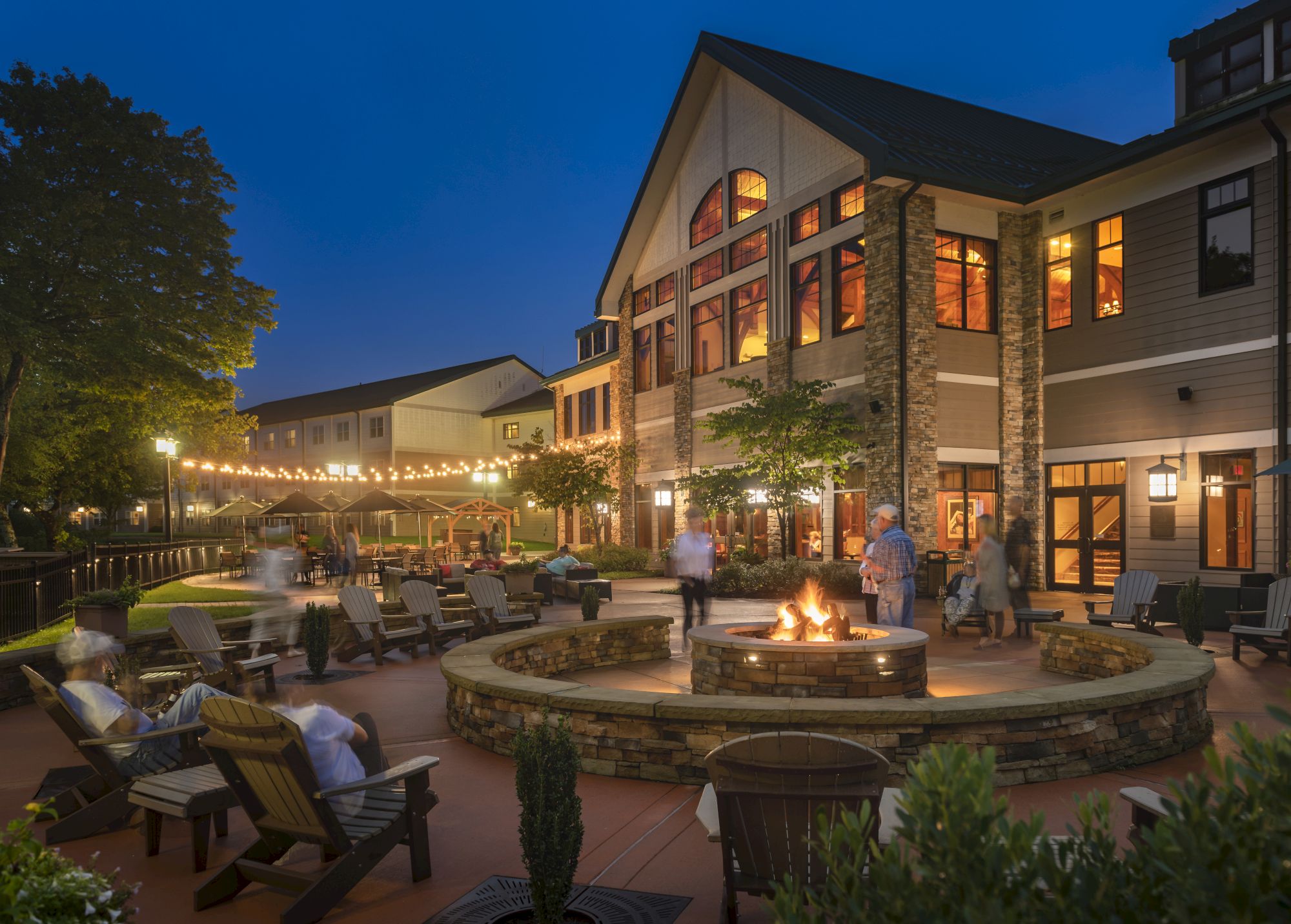 image Golden hour settles over the Adirondack-style lodge, setting the tone for cozy evenings in front of a fire pit and patio.