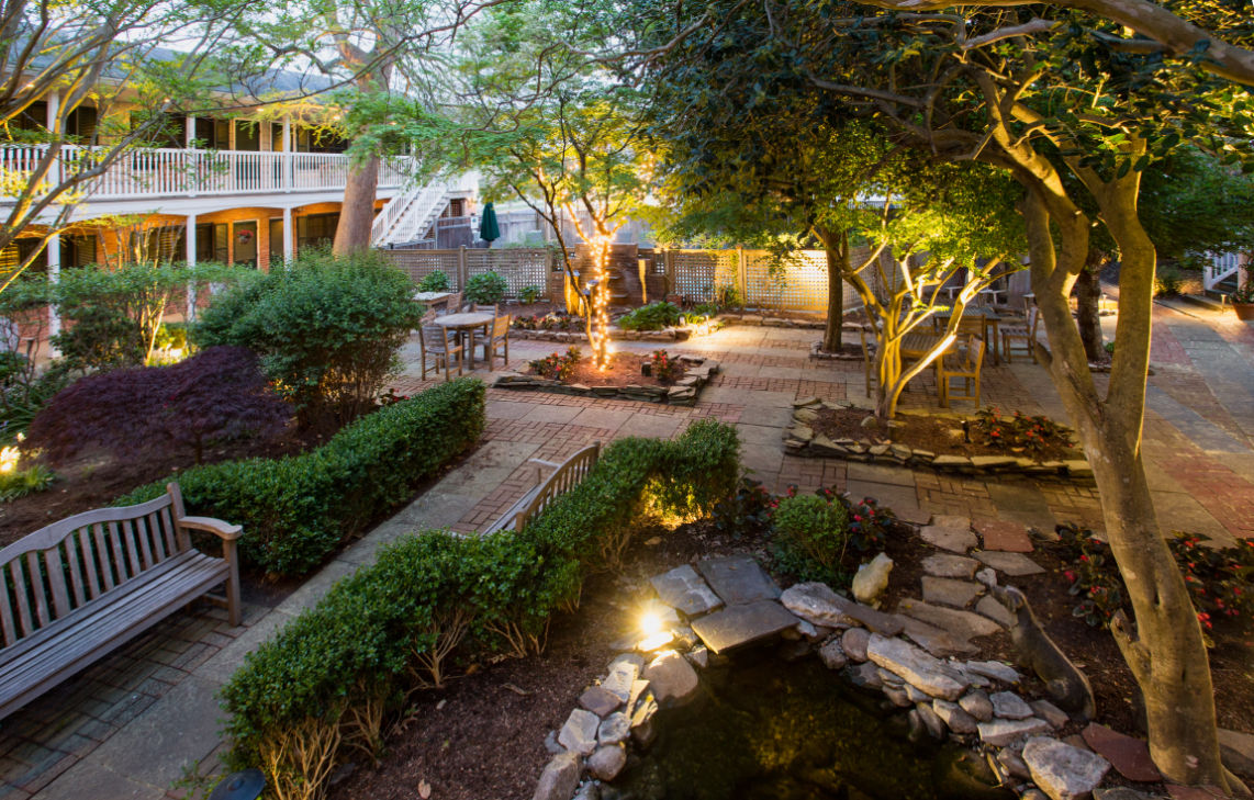 image Cozy seating nestled among beautifully landscaped gardens, offering a perfect blend of nature and comfort.