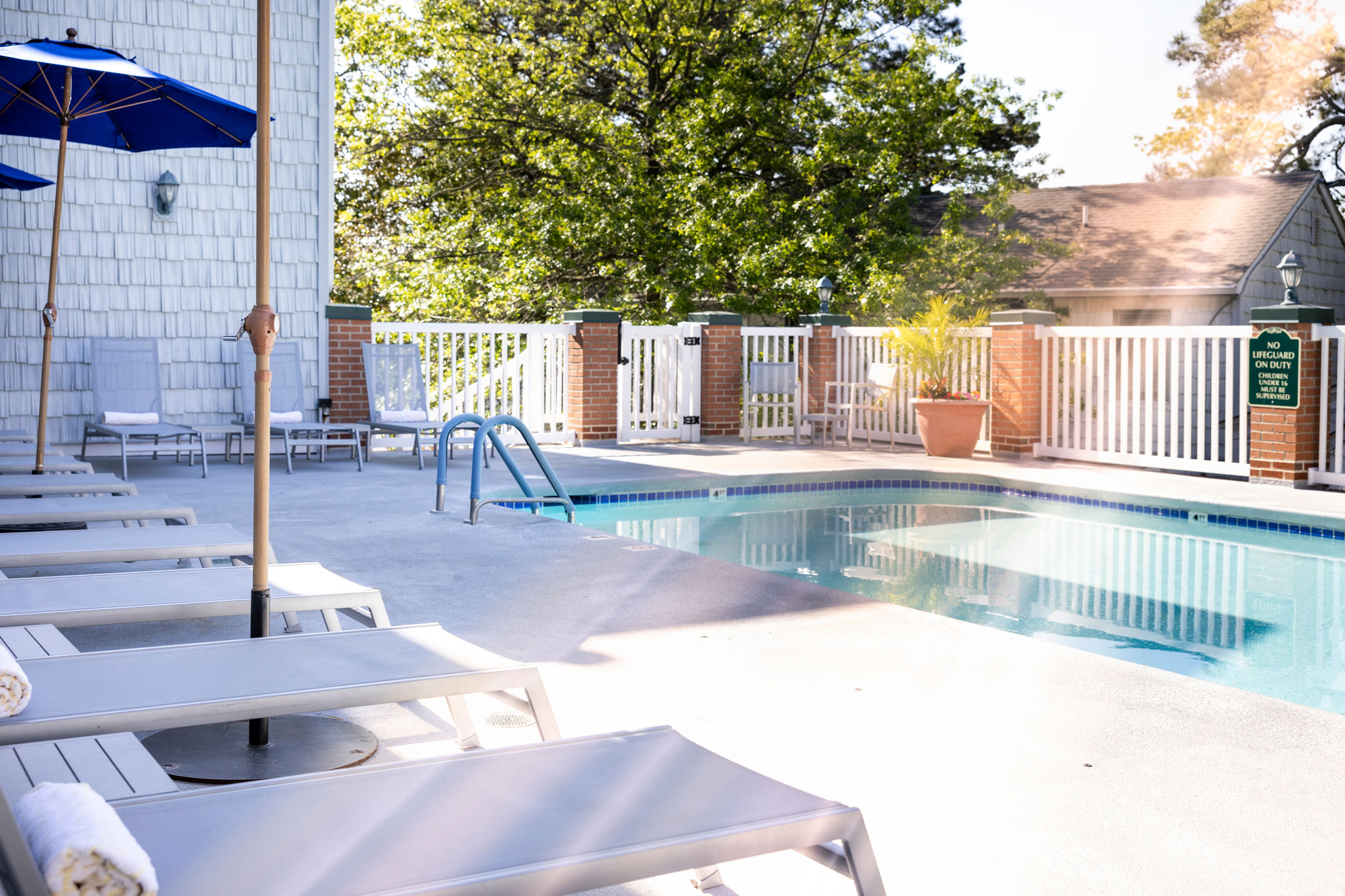image Tranquil waters and inviting lounge chairs set the scene for a peaceful retreat just steps from the shore.
