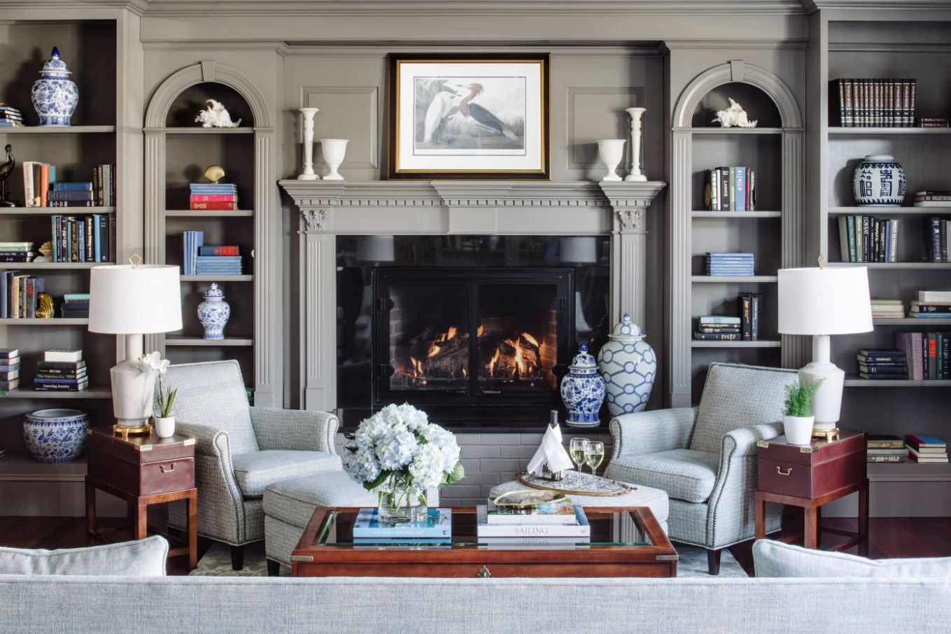 image Cozy up by the fire in this inviting library lounge, where timeless charm meets modern comfort.