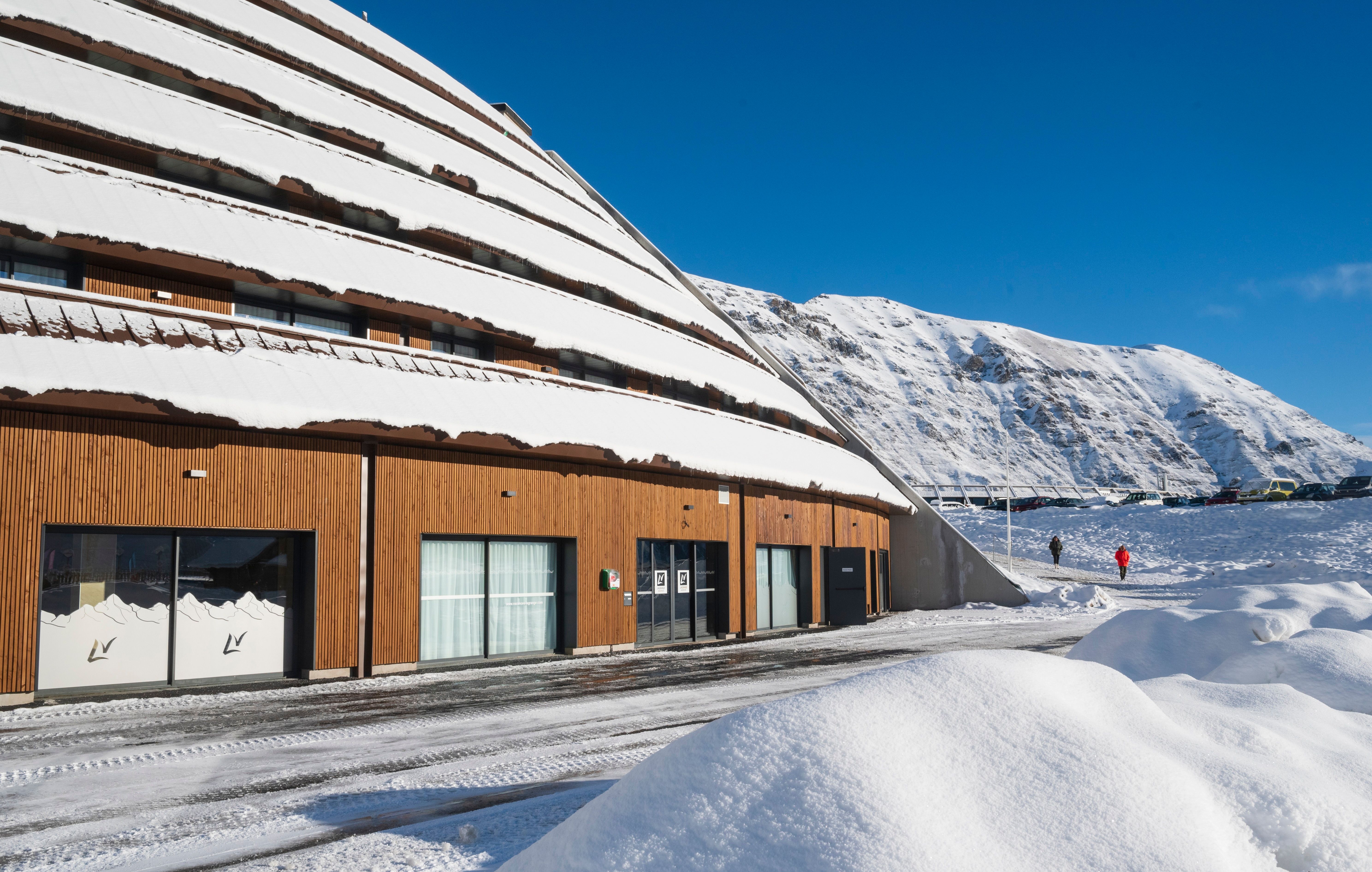 image Modern architecture meets stunning snowy landscapes—experience the ultimate ski vacation with unmatched convenience. 