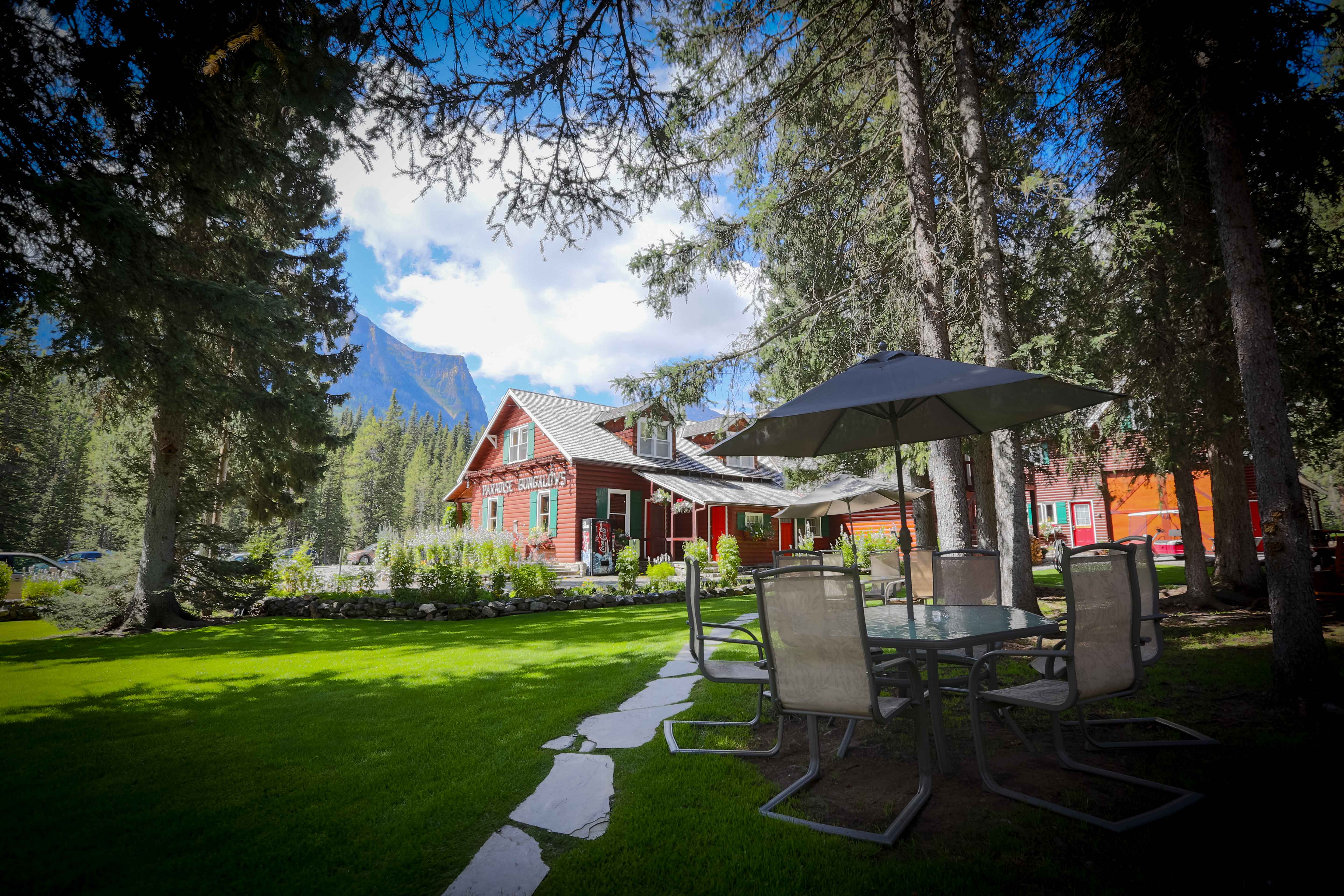 image Nestled among towering evergreens, the lodge suites offer a peaceful escape with a perfect balance of rustic charm and modern comfort.$
