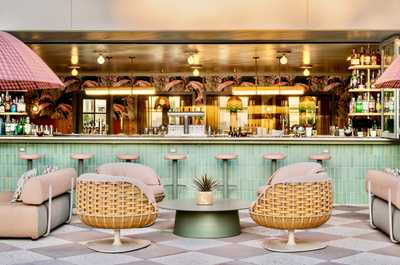 Sip and savor in a space where golden hour glow meets sleek design and lively conversation.