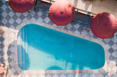 Take in the scene from above, where bold patterns and soft shade frame the perfect oasis retreat.