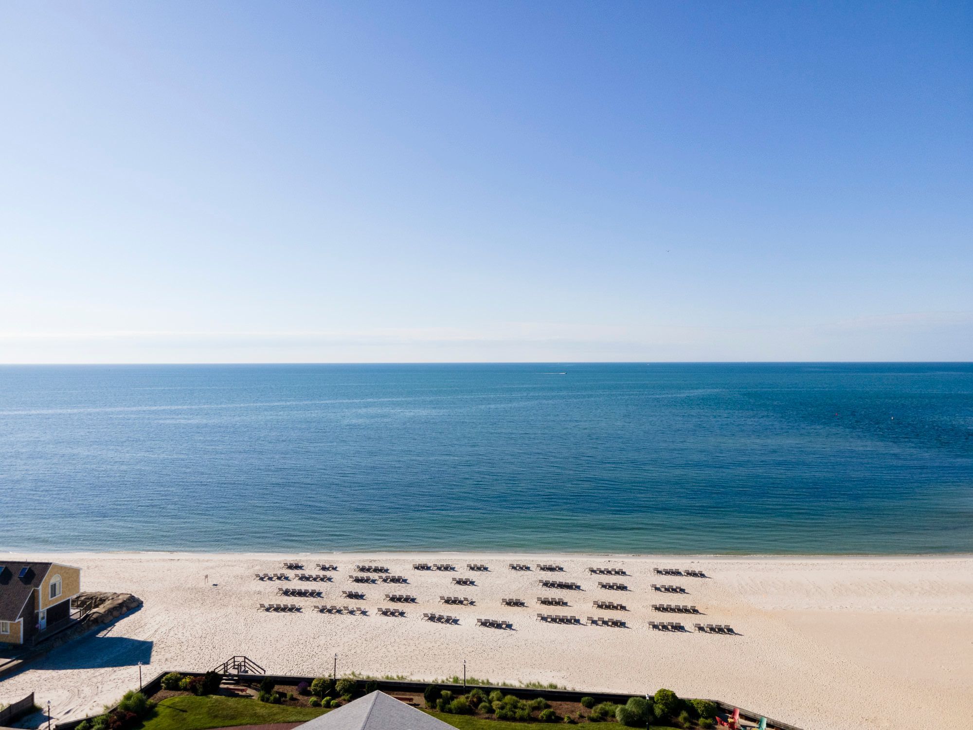 image Greet the day with toes in the sand and the gentle rhythm of waves lapping the shore just steps away.